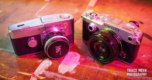 Two Olympus PEN-F cameras—one from the early 1960s, and one from the early 2010s